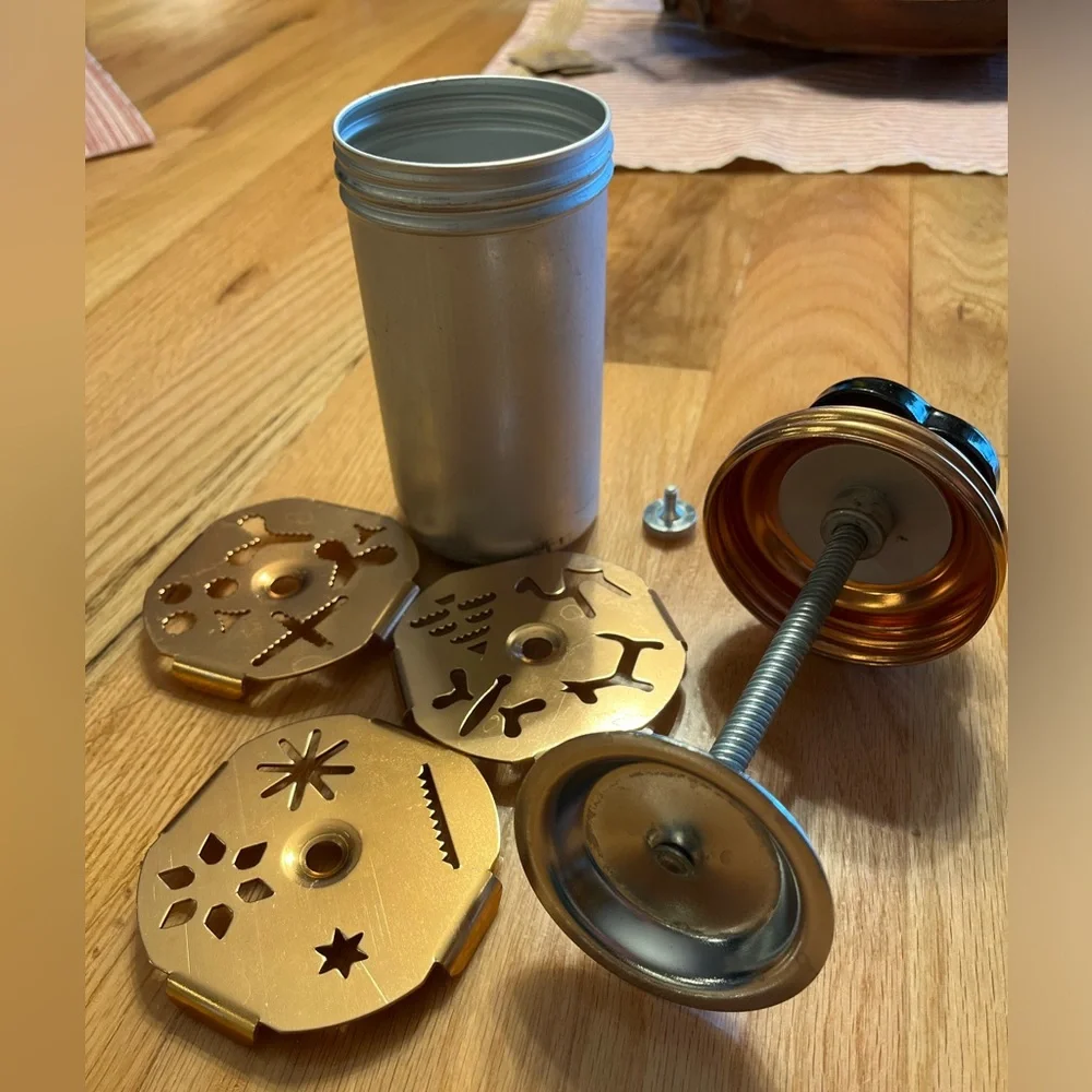 Cookie Press - aluminum and copper-tone with 3 discs that each have 4 designs